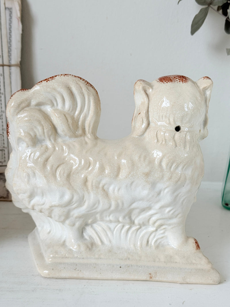 Pair of antique standing Staffordshire Pekingese dogs in rust red and white with blue painted bows