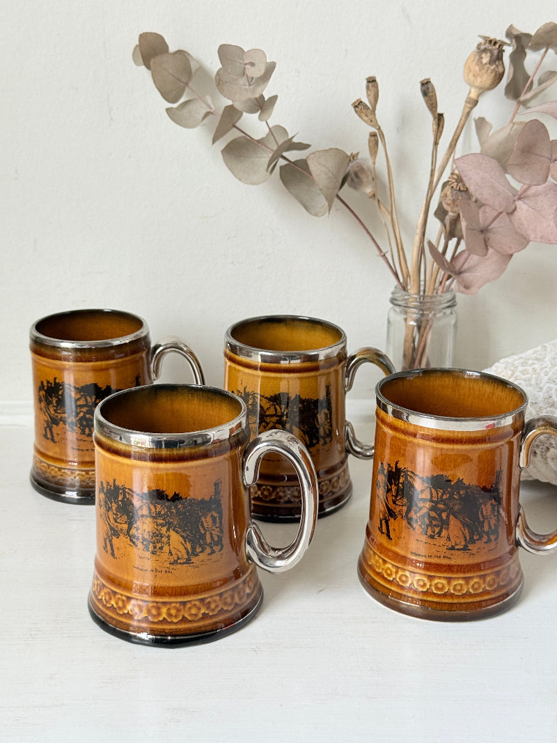 Set of 4 Ridgways stoneware tankard mugs photographed on a white surface in amber brown treacle glaze with black Coaching Days and Coaching Ways transfer scenes