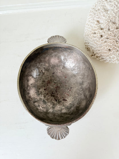 Antique Christofle silver plate bowl with decorative handle, photographed on a white surface.