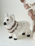 Vintage shell ram ornament in cream and brown, photographed on a white surface