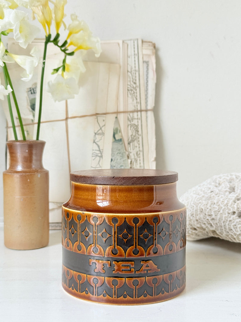 Hornsea Heirloom tea storage jar in autumn brown stoneware with teak lid photographed on a white surface
