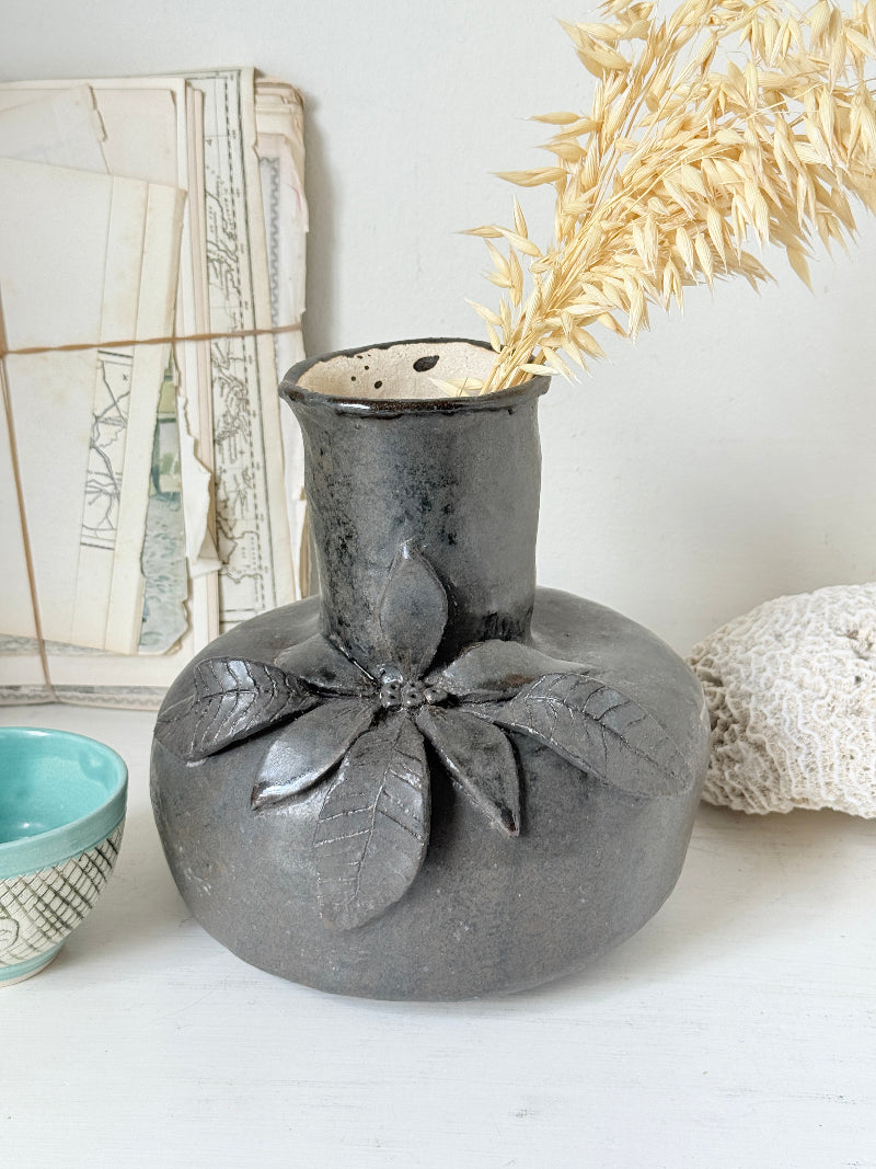 Studio pottery ceramic vase with liquorice grey glaze, applied floral and leaf detail and rounded handmade form