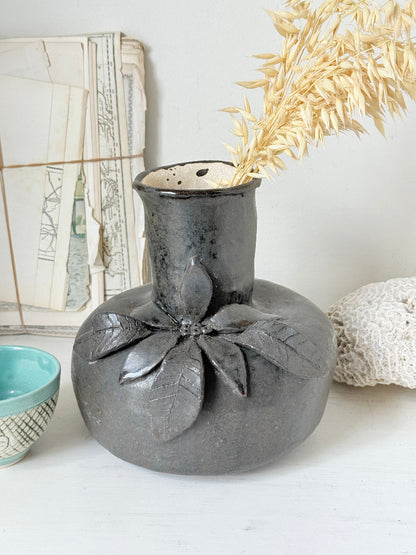 Studio pottery ceramic vase with liquorice grey glaze, applied floral and leaf detail and rounded handmade form