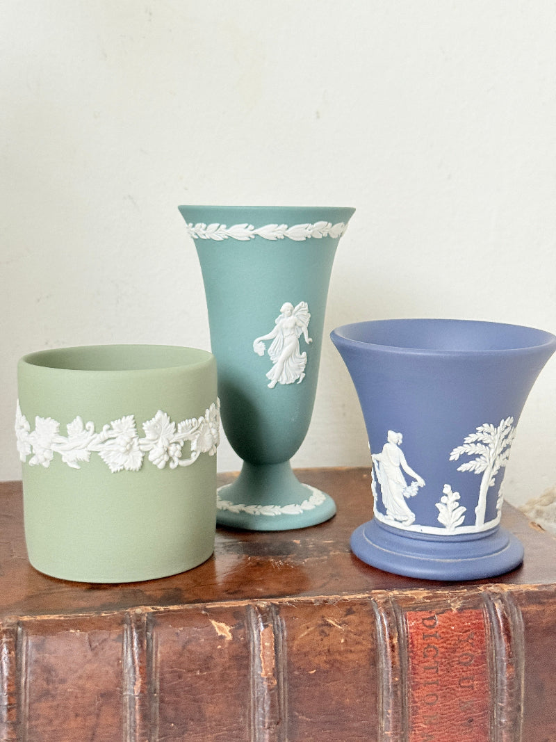 Trio of vintage Wedgwood Jasperware vases in green and blue with white relief decoration, photographed on a white surface