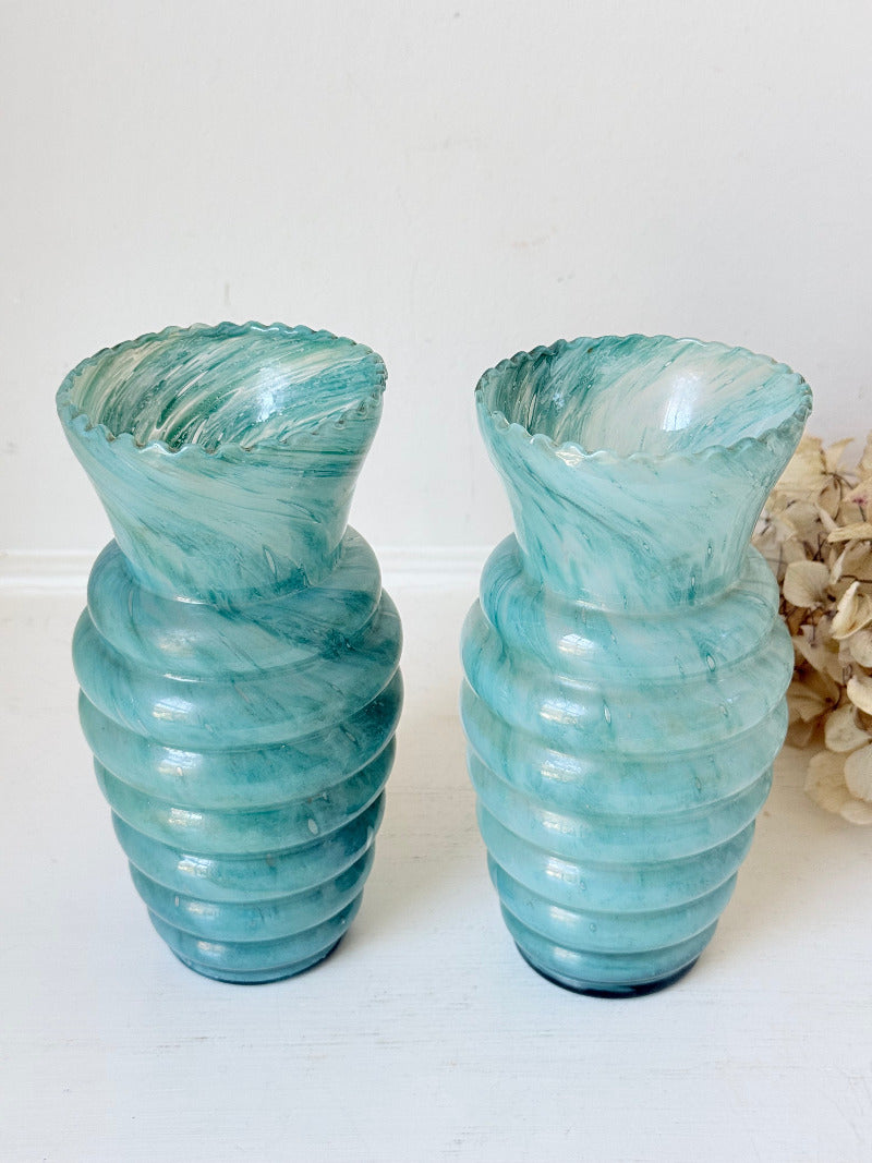 Pair of vintage aqua blue glass vases with beehive pattern and scalloped edges, photographed on a white surface