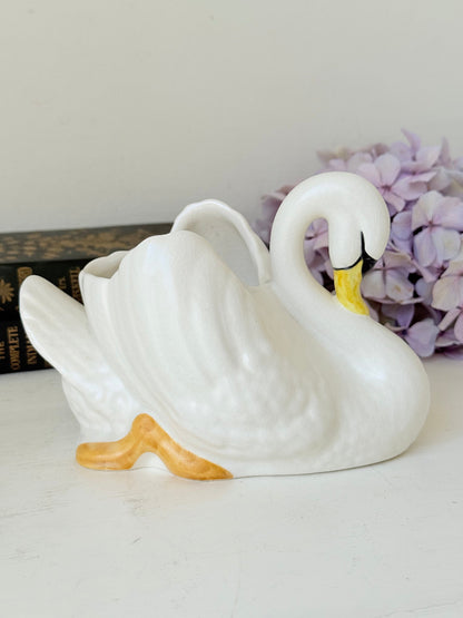 Vintage Sylvac swan planter in white ceramic with yellow beak and feet, styled on a white surface