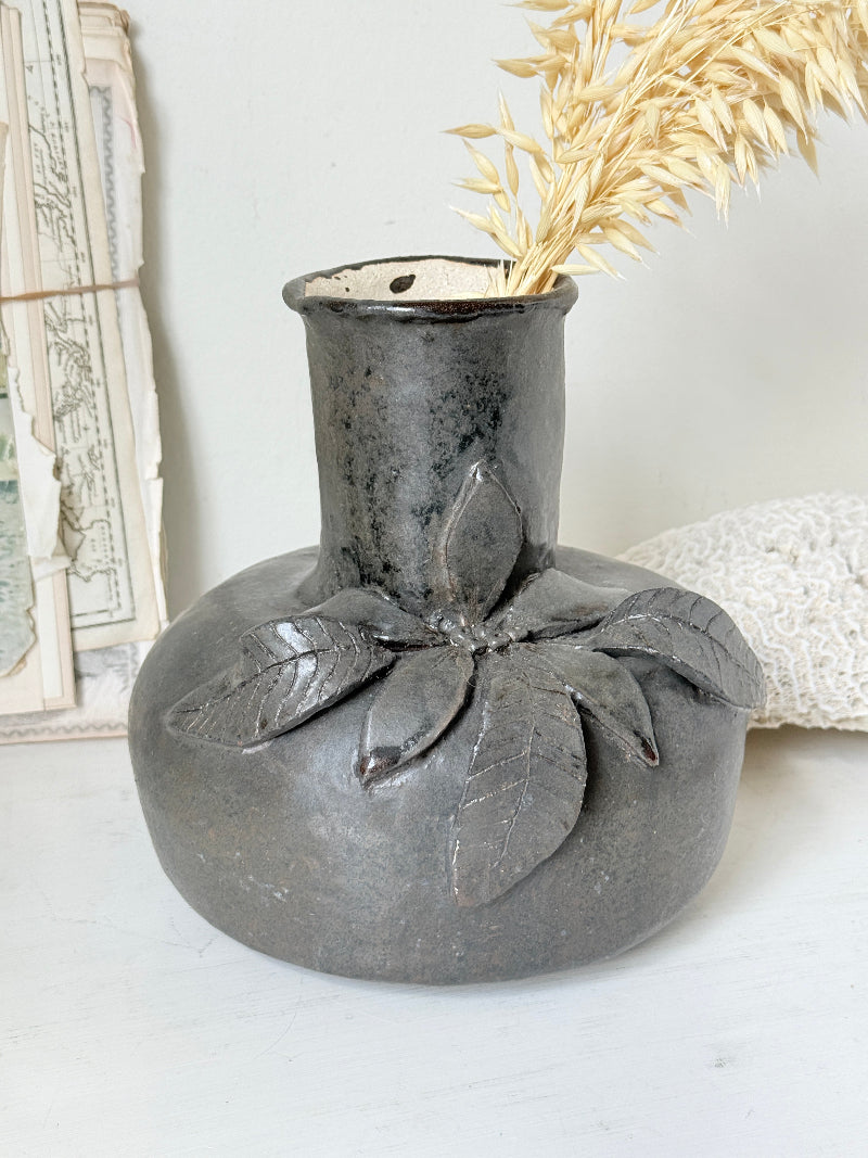 Studio pottery ceramic vase with liquorice grey glaze, applied floral and leaf detail and rounded handmade form