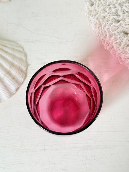 Vintage cranberry glass beaker with honeycomb optic pattern, deep pink colour and textured moulded glass for shelf styling