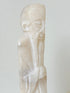 vintage alabaster gentleman figure on square base with carved detail, photographed on white surface with hydrangea flowers.