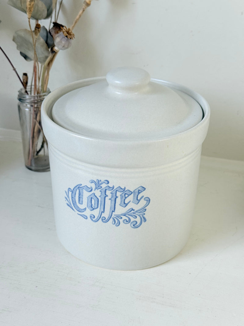 Pfaltzgraff Yorktowne stoneware coffee jar with blue floral motif and lid, photographed on a white surface