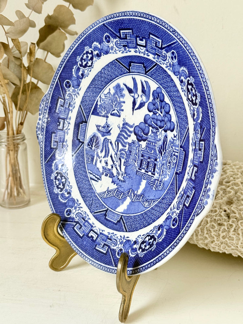 Blue Willow serving plate with cobalt blue transfer pattern shown on a white surface.