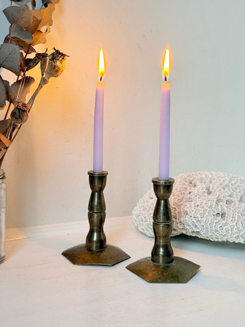 Pair of miniature brass candlesticks with hex bases photographed on a white surface