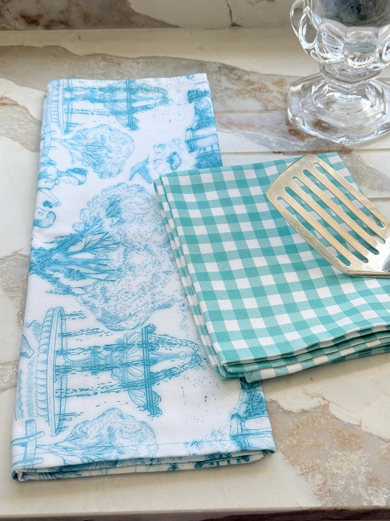 The Blue Loft toile cotton tea towel in turquoise on white with rural scenic print