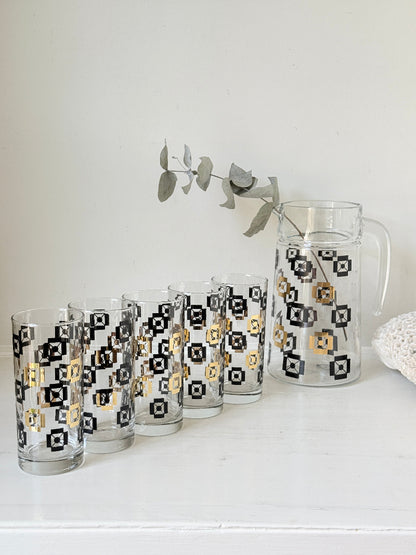 Mid century black and gold glass drinks set with jug and five highball tumblers in a geometric medallion pattern