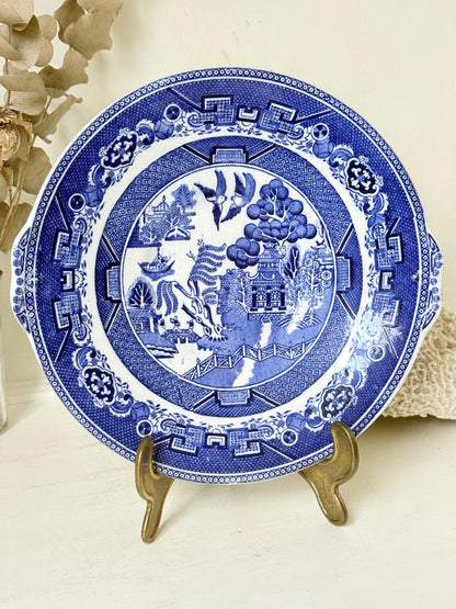 Blue Willow serving plate with cobalt blue transfer pattern shown on a white surface.