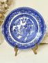 Blue Willow serving plate with cobalt blue transfer pattern shown on a white surface.