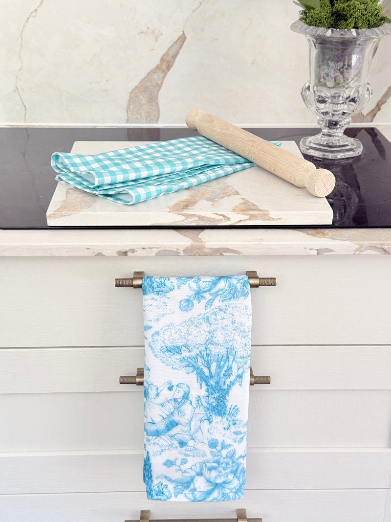 Blue Loft cotton tea towel duo with turquoise gingham check and blue toile pattern photographed in a kitchen setting.