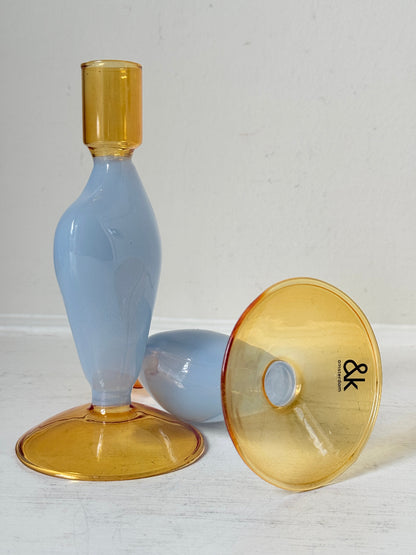 Pair of &amp;Klevering Amsterdam Flux glass candle holders in light blue and amber with pink taper candles