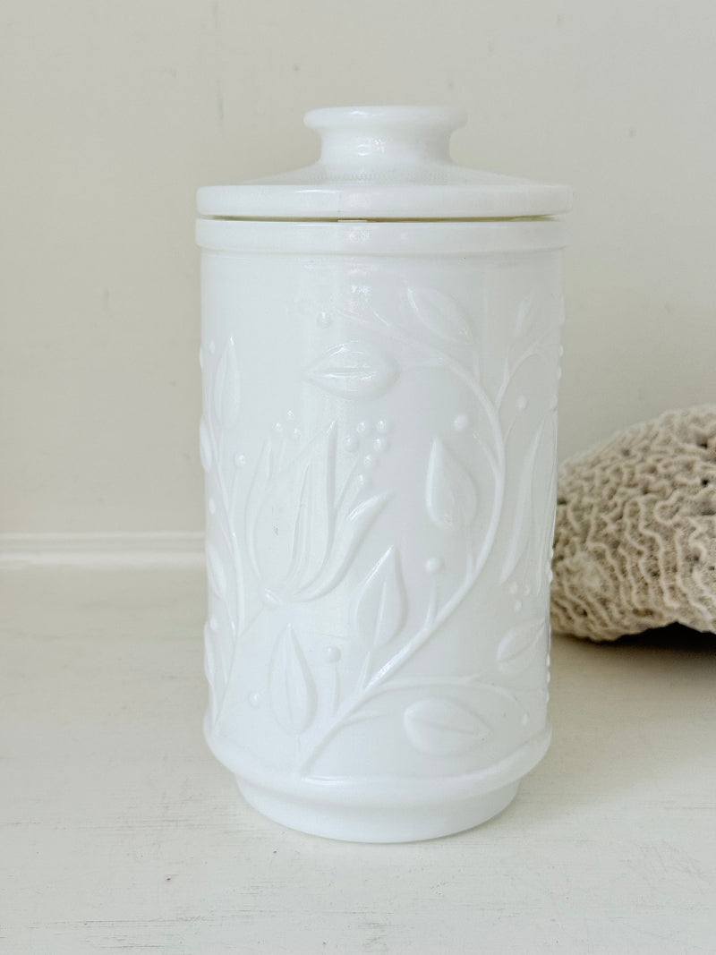 French opale glass jar with floral raised design, white vintage milk glass, shown on white background