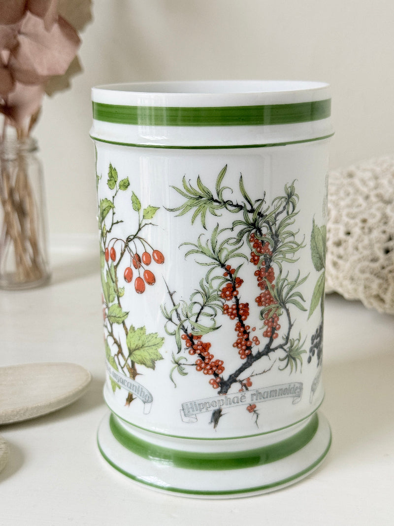 Vintage Kaiser W Germany porcelain utensil jar with botanical floral pattern and green rim photographed on a white surface