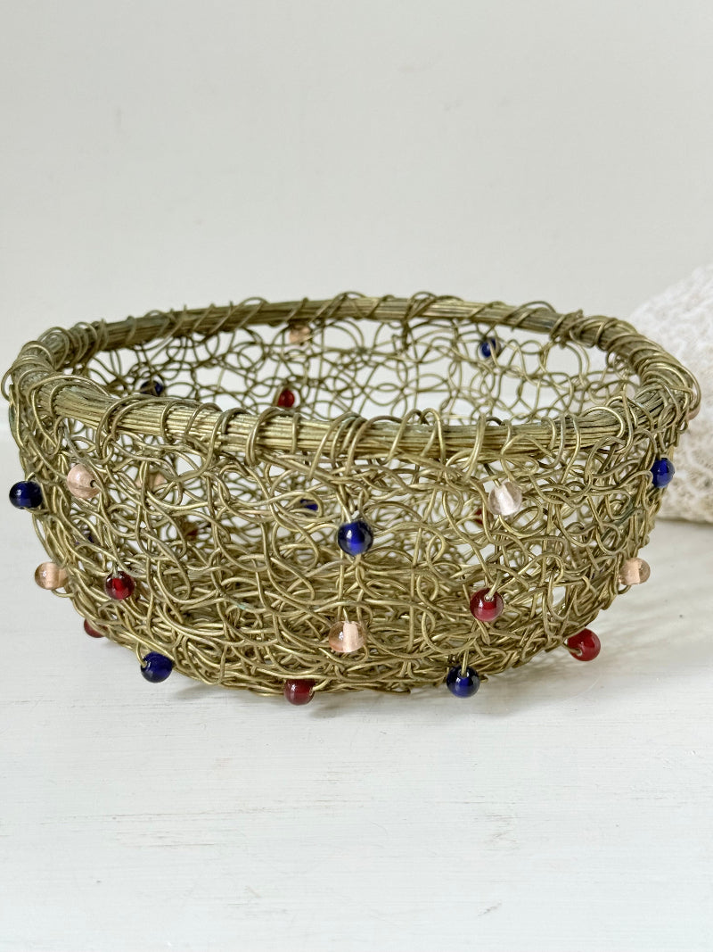 Vintage brass wire basket with coloured glass beads, photographed from multiple angles on a white surface
