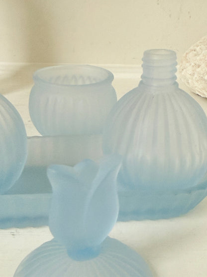 Vintage powder blue frosted glass dresser set with tray and three matching pieces, photographed on a white surface