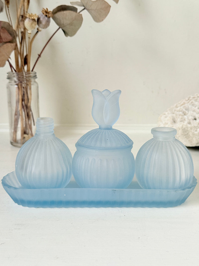 Vintage powder blue frosted glass dresser set with tray and three matching pieces, photographed on a white surface