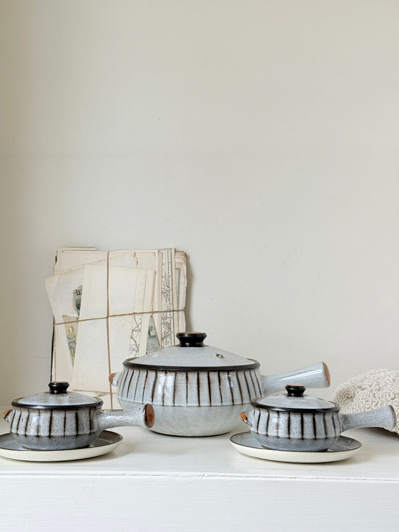 Denby Studio stoneware casserole and soup bowl set in grey and rust photographed on a white surface