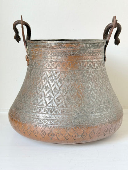 antique Middle Eastern water ewer with engraved diamond and foliate pattern and copper base, displayed on white surface