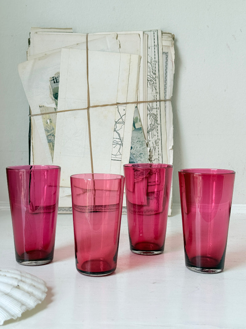 Set of 4 vintage cranberry glass tumblers in tall beaker form with deep pink colour and one slightly paler glass