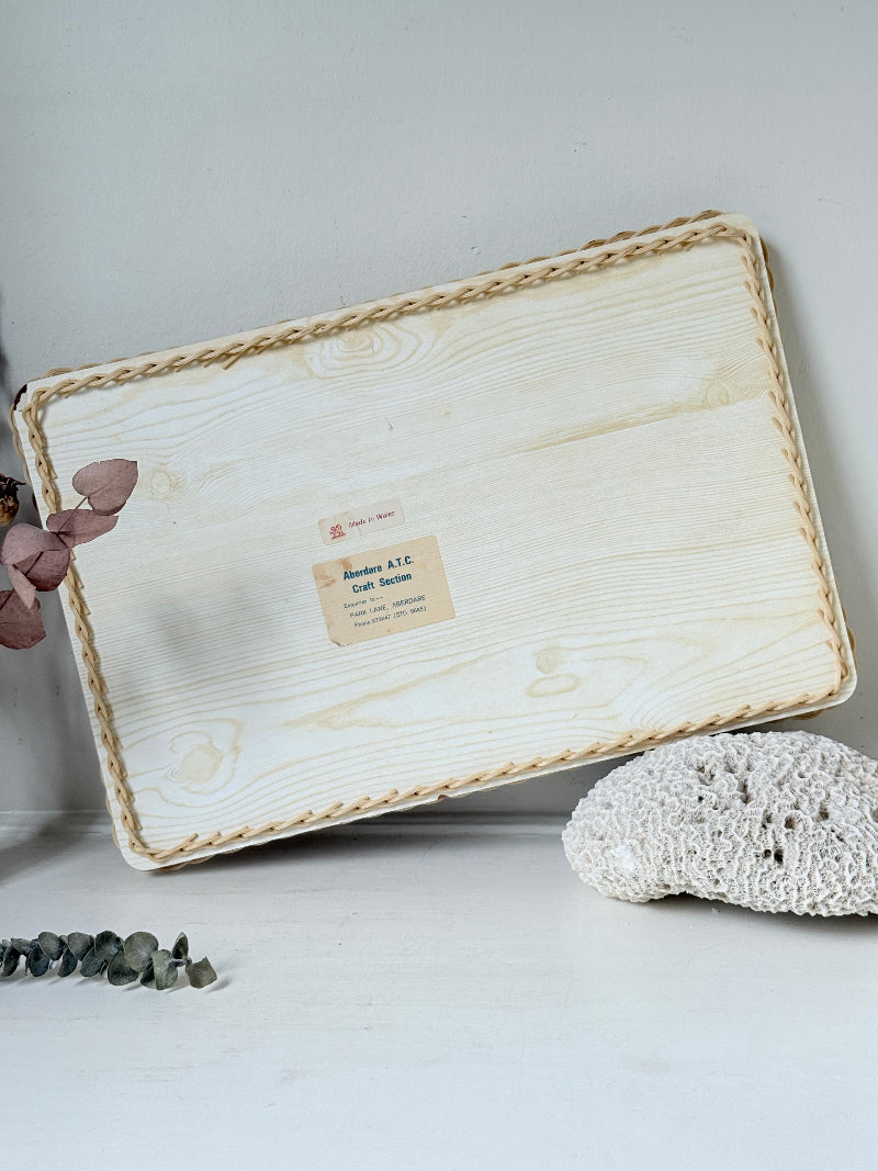 Vintage melamine tray with wicker effect edge and Victorian street scene, photographed on a white surface