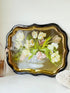 Large vintage printed tulip tray with scalloped edge and black lacquered finish, photographed on white surface.