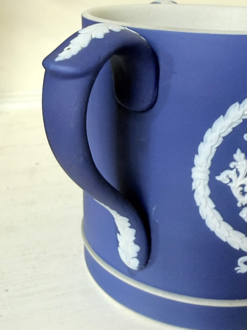 Adam’s blue jasperware loving cup with white classical relief decoration photographed on a white surface.
