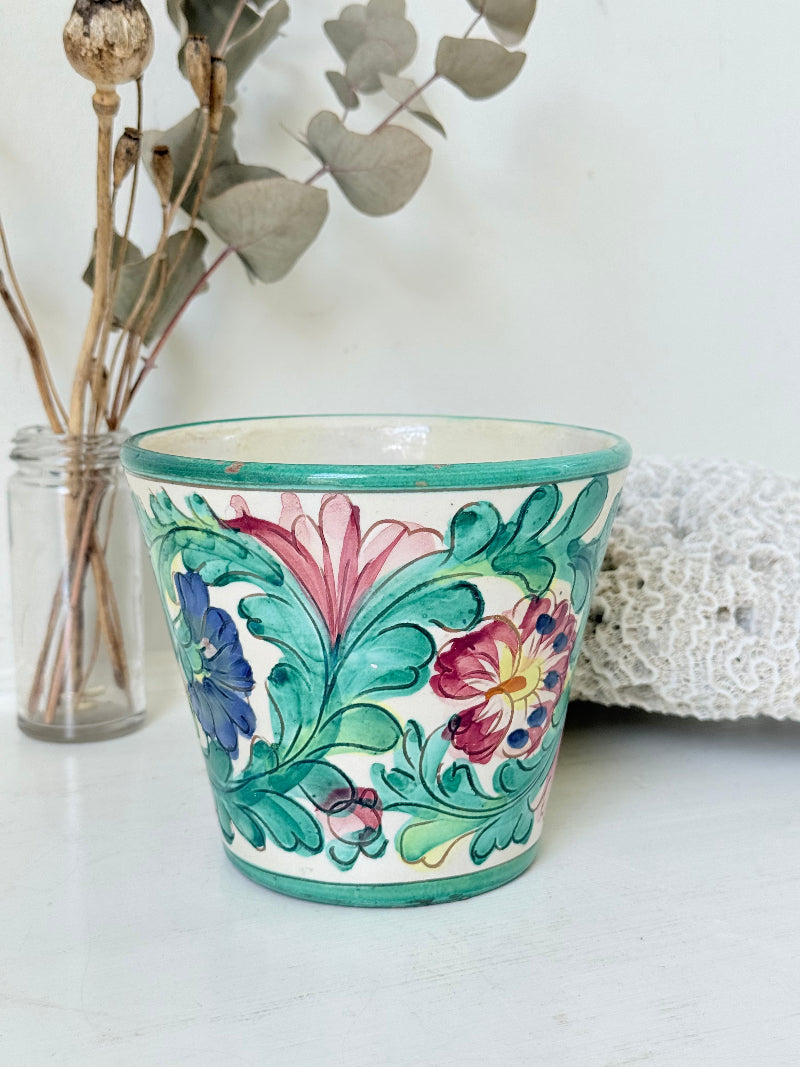Italian handmade pot with colourful floral decoration, glazed finish, marked base, photographed on white surface.