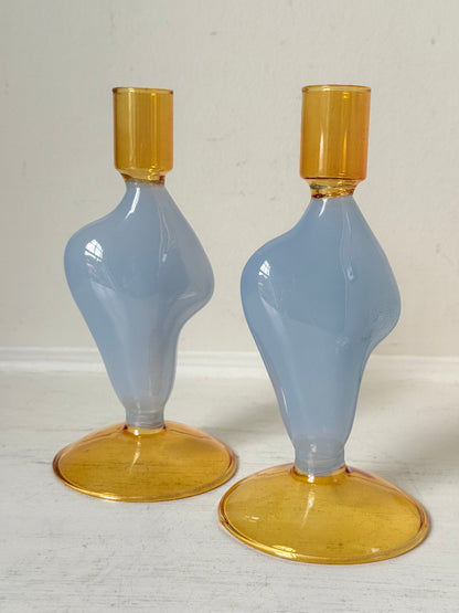 Pair of &amp;Klevering Amsterdam Flux glass candle holders in light blue and amber with pink taper candles