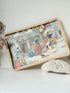 Vintage melamine tray with wicker effect edge and Victorian street scene, photographed on a white surface