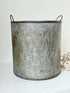 Vintage galvanised metal bin with handles, photographed on a white surface.