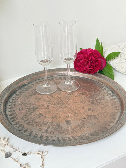 Vintage hand engraved copper tray with sunburst centre, decorative border and aged verdigris patina for wall or tabletop styling