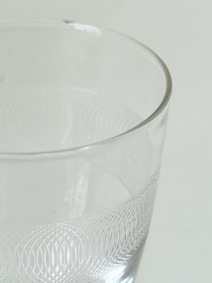 Set of six vintage etched clear glasses with decorative banding, one with a tiny rim chip, photographed on white surface.