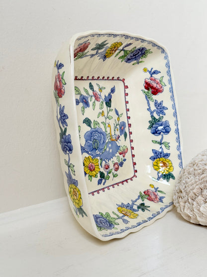 Vintage Mason’s ironstone serving dish with square form and spring floral pattern in blue, pink, yellow, and green, photographed on a white surface