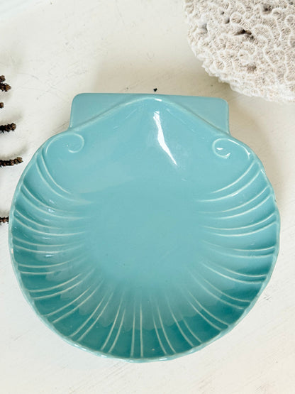 Poole Pottery scallop shell serving dish in sea blue glaze photographed on a white surface