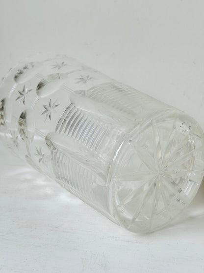 Vintage Stuart crystal cut glass vase with floral and star design, photographed on a white surface.