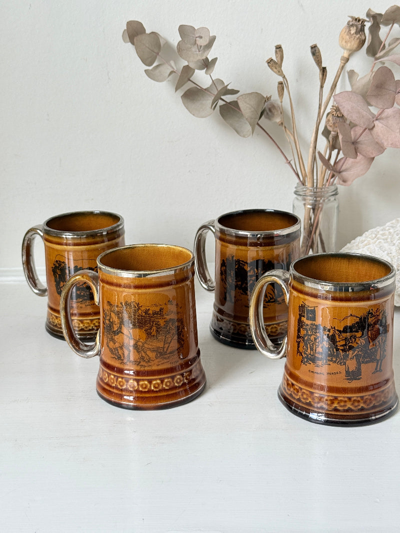 Set of 4 Ridgways stoneware tankard mugs photographed on a white surface in amber brown glaze with black Coaching Days and Coaching Ways transfer scenes