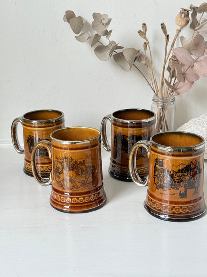Set of 4 Ridgways stoneware tankard mugs photographed on a white surface in amber brown glaze with black Coaching Days and Coaching Ways transfer scenes