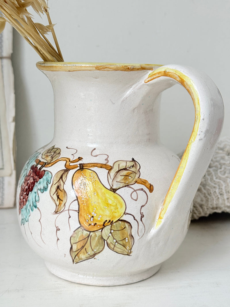Vintage Deruta Italian hand painted maiolica jug with fruit and vine motif, yellow rim and Mediterranean ceramic styling