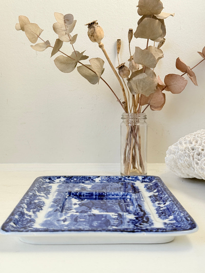 Vintage Wedgwood blue and white rectangular transferware plate with scenic design photographed on a white surface