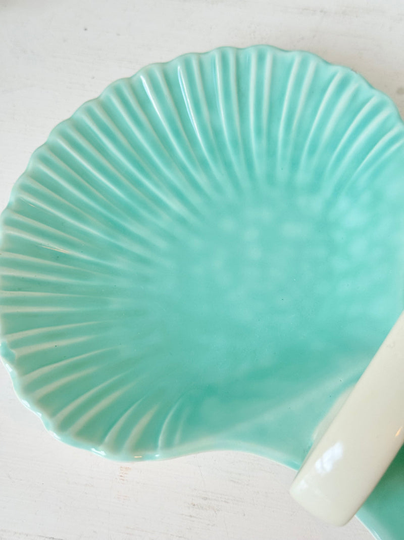 Poole Pottery Shagreen double scallop dish in sea green glaze photographed on a white surface
