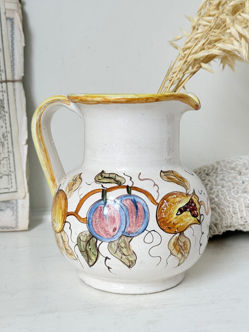 Vintage Deruta Italian hand painted maiolica jug with fruit and vine motif, yellow rim and Mediterranean ceramic styling