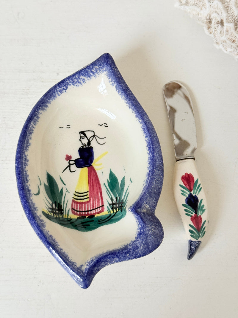 Vintage Quimper butter dish with ceramic knife, hand painted Breton figure, photographed on a white surface