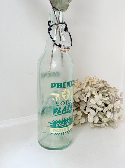 vintage french soda bottle phenix aqua green glass with ceramic swing top 31cm on white surface